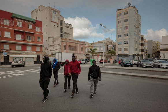 A group of Senegalese men who recently arrived in Gran Canaria after crossing the Atlantic route from Gambia walk through Las Palmas on January 19, 2026. Migrants leaving west Africa and traveling up  ...