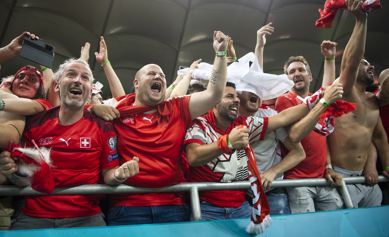 Swiss fans celebrate de victory during the Euro 2020 soccer tournament round of 16 match between France and Switzerland at the National Arena stadium, in Bucharest, Romania, Monday, June 28, 2021. (KE ...