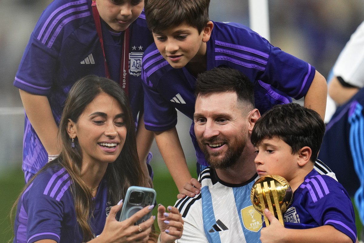 Argentina's Lionel Messi celebrates with his family after winning the World Cup final soccer match between Argentina and France at the Lusail Stadium in Lusail, Qatar, Sunday, Dec.18, 2022. (AP P ...