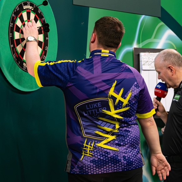 27th December 2023, Alexandra Palace, London, England 2023/24 PDC Paddy Power World Darts Championships Day 10 Evening Session Luke Littler retrieves the winning dart from double top that secured his  ...