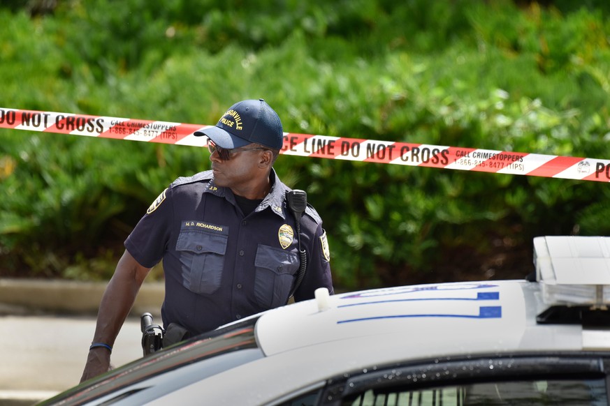 Police investigate the scene of a multiple shooting Sunday, Aug. 26, 2018, at the Jacksonville Landing in Jacksonville, Fla., during a Madden Championship Series video game tournament. A gunman opened ...