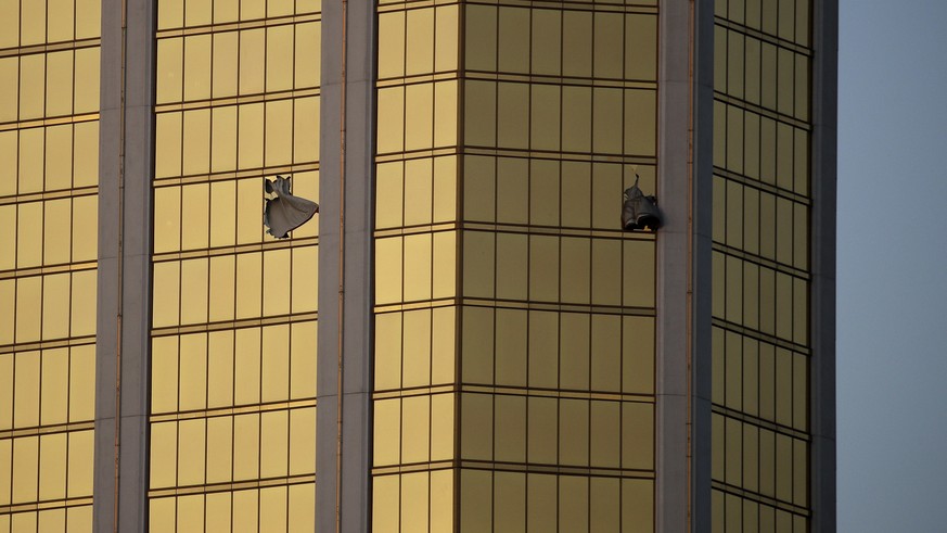 Drapes billow out of broken windows at the Mandalay Bay resort and casino Monday, Oct. 2, 2017, on the Las Vegas Strip following a deadly shooting at a music festival in Las Vegas. A gunman was found  ...