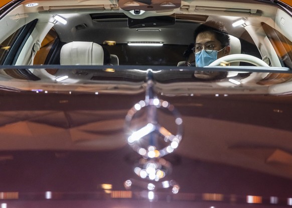 epa09146565 A visitor seats in the Mercedes-Maybach S 480 4MATC car on display in the AMG Mercedes trade fair stand during a second media day of the Auto Shanghai 2021 motor show in Shanghai, China, 2 ...