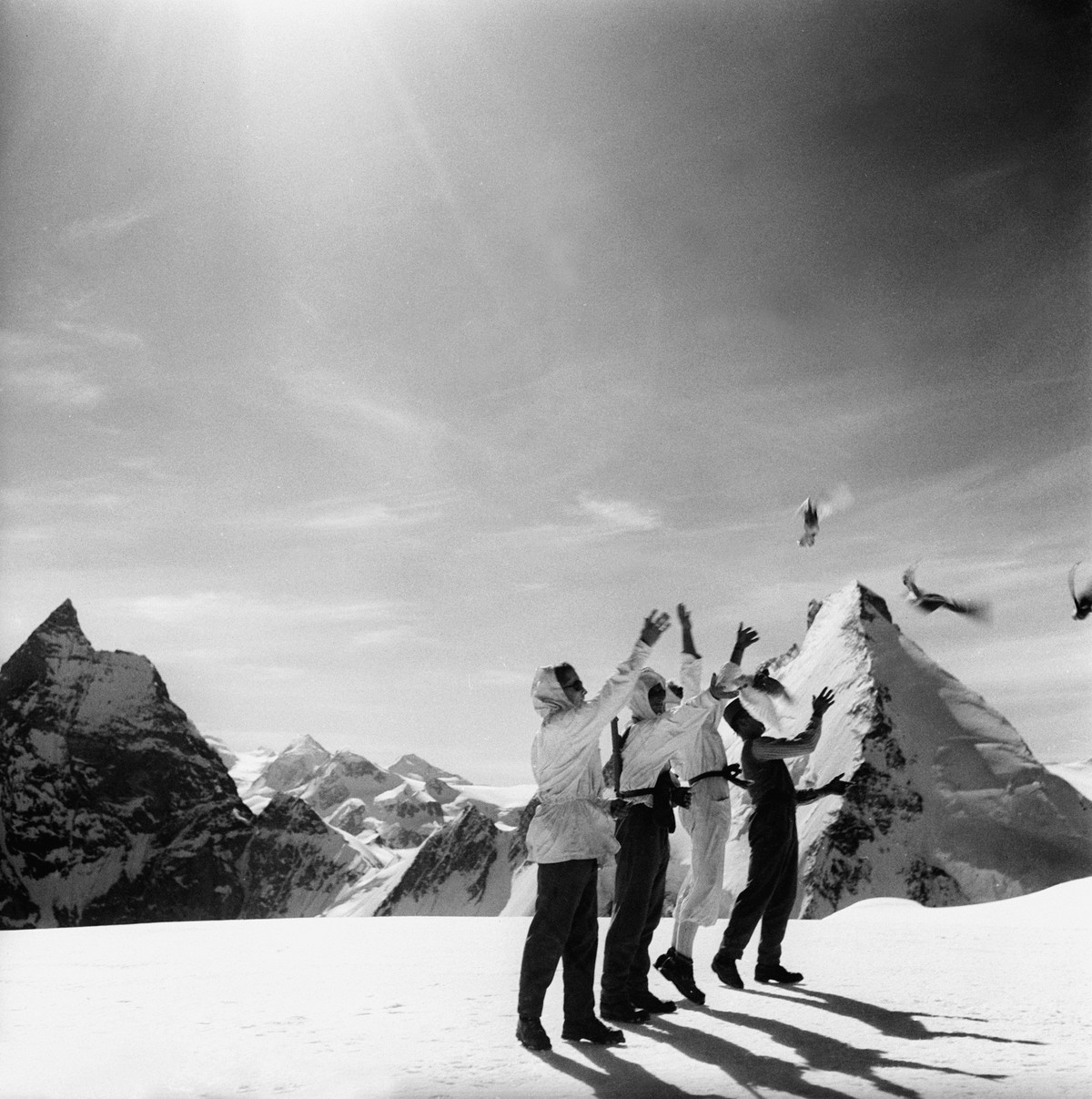 Soldiers of the Swiss Armed Forces Mountain Service send a 1st of August (Swiss National Day) message to General Henri Guisan with homing pigeons, pictured on the Arolla Glacier, Switzerland, in July  ...