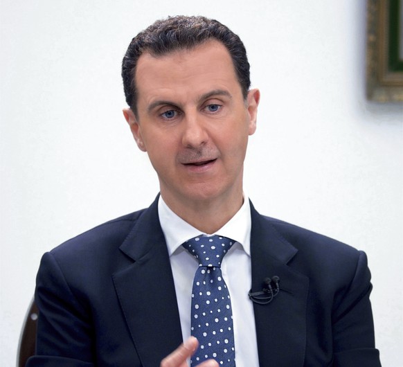 FILE - In this photo released by the Syrian official news agency SANA, Syrian President Bashar Assad, speaks during an interview with Hong-Kong based Phoenix TV in Damascus, Syria, March 11, 2017. The ...