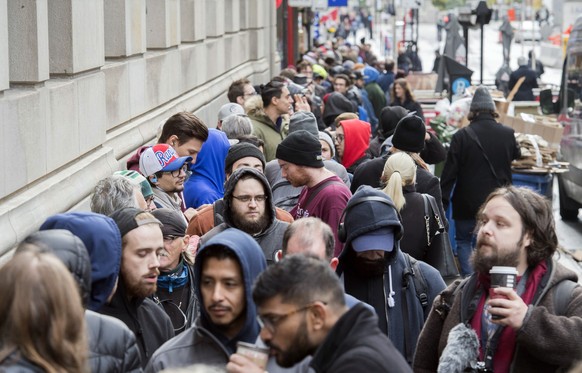 People wait in line to purchase legal cannabis products outside a government cannabis store in Montreal, Wednesday, Oct. 17, 2018. Canada became the largest country with a legal national marijuana mar ...