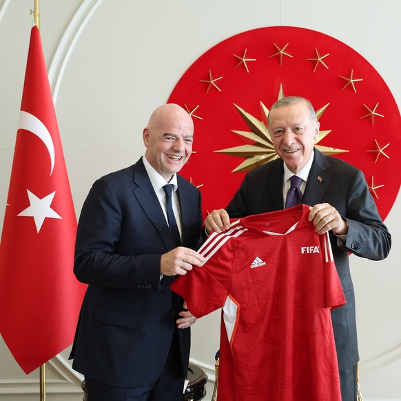 epa10683650 A handout photo made available by the Turkish President Press Office shows, Turkish President Recep Tayyip Erdogan (R) and FIFA President Gianni Infantino (L) pose for a photo during their ...
