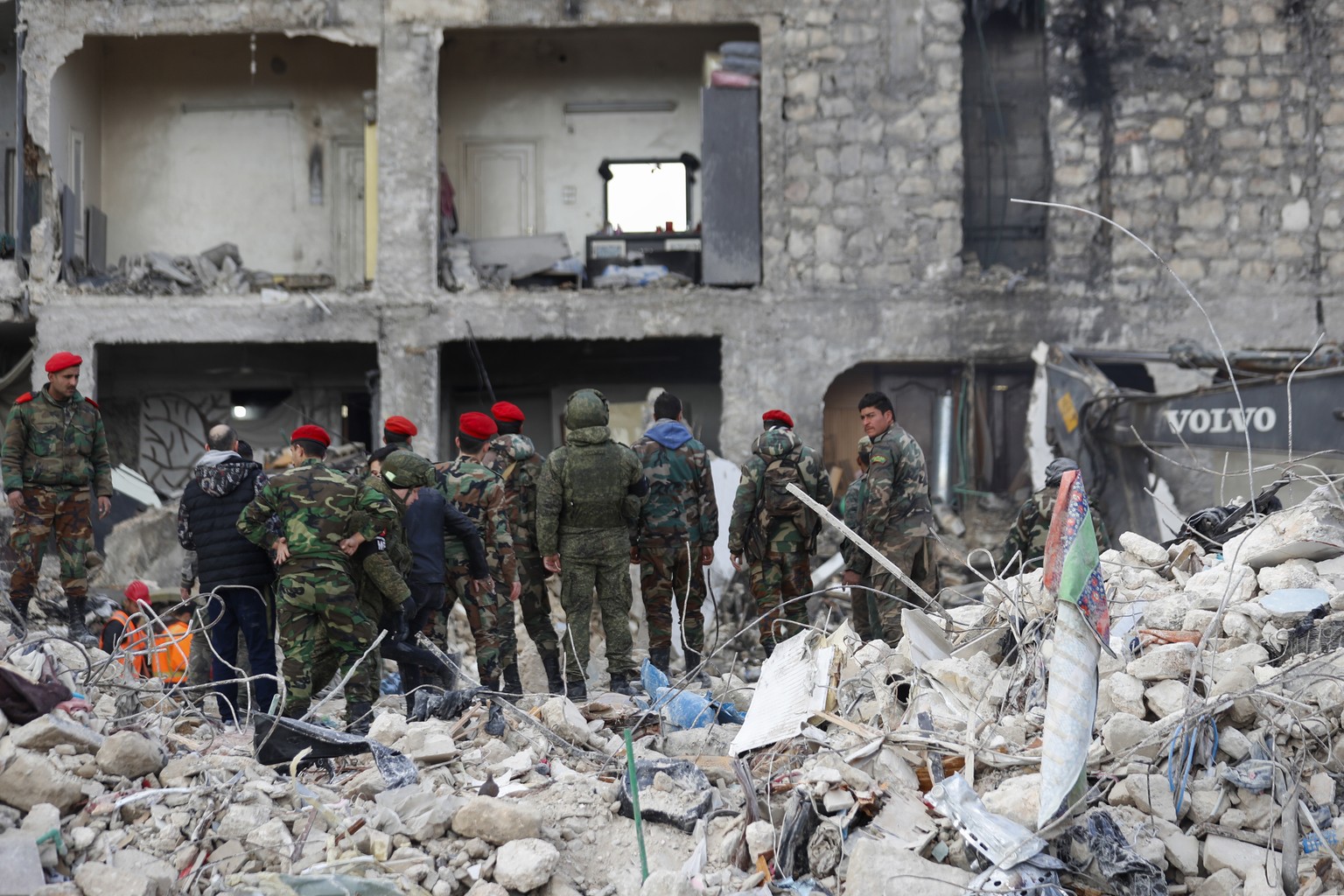 Russian soldiers and Syrian security forces inspect the wreckage of collapsed buildings in Aleppo, Syria, Tuesday, February 7, 2023. Rescuers rushed Tuesday to find survivors in the rubble of thousands of…