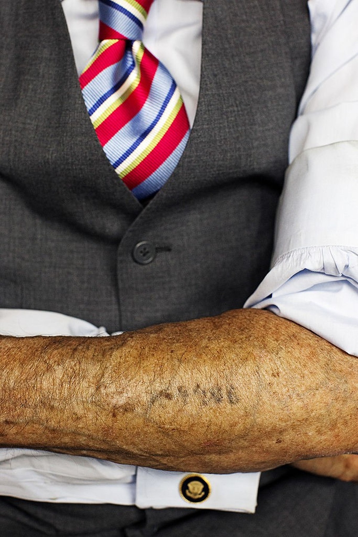 Brooklyn, New York - October 10, 2012: Martin Greenfield was tattooed the serial number "A4406" upon entering Auschwitz concentration camp. The cufflinks (from President Reagan's White  ...