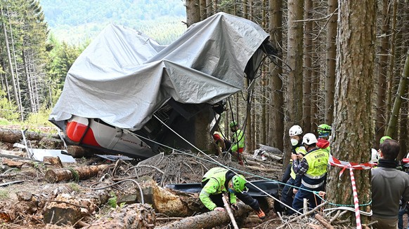 epa09623604 Carabinieri and Soccorso Alpino forces inspect the site where the Stresa-Alpino?Mottarone cable car crashed to the ground after a cable snapped on 23 May 2021, in Mottarone Stresa, norther ...