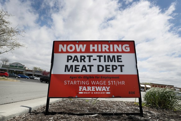 A now hiring sign is displayed in front of a grocery store, Wednesday, April 29, 2020, in Des Moines, Iowa. As of mid-April, about 26 million Americans had filed unemployment claims in the first five  ...