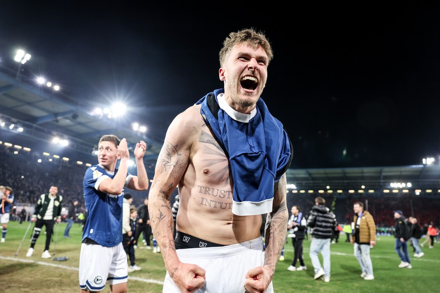 epa12003984 Joel Grodowski of Bielefeld celebrates winning the DFB Cup semi final match between Arminia Bielefeld and Bayer 04 Leverkusen in Bielefeld, Germany, 01 April 2025. EPA/CHRISTOPHER NEUNDORF ...