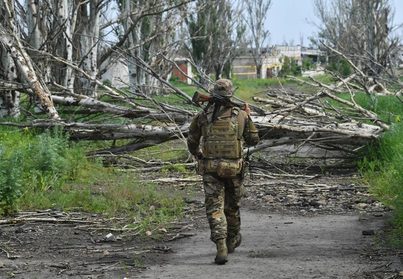 Russia Ukraine Military Operation Frontline 8443059 26.05.2023 A Russian serviceman patrols the area near the frontline town of Artyomovsk, also known as Bakhmut, in the course of Russia s military op ...
