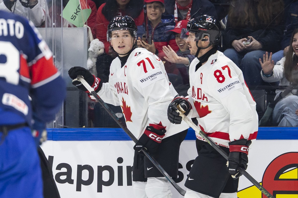 Canada's Macklin Celebrini, left, and Canada's Sidney Crosby, right, during the 2026 IIHF Men's Ice Hockey World Championship preliminary round group B game between Italy and Canada, at ...
