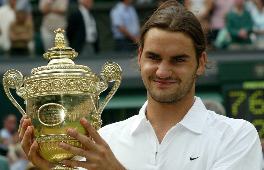 epa10185790 (FILE) - Swiss Roger Federer holds the trophy after winning the Men&#039;s Final against Mark Philippoussis of Australia at the All England Lawn Tennis Championships in Wimbledon, Sunday 0 ...