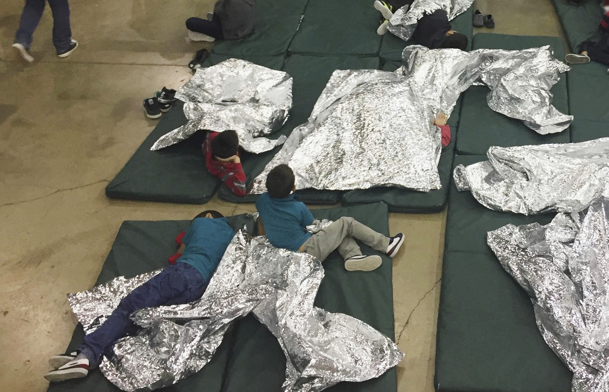 FILE - In this Sunday, June 17, 2018, file photo provided by U.S. Customs and Border Protection, people who've been taken into custody related to cases of illegal entry into the United States, re ...