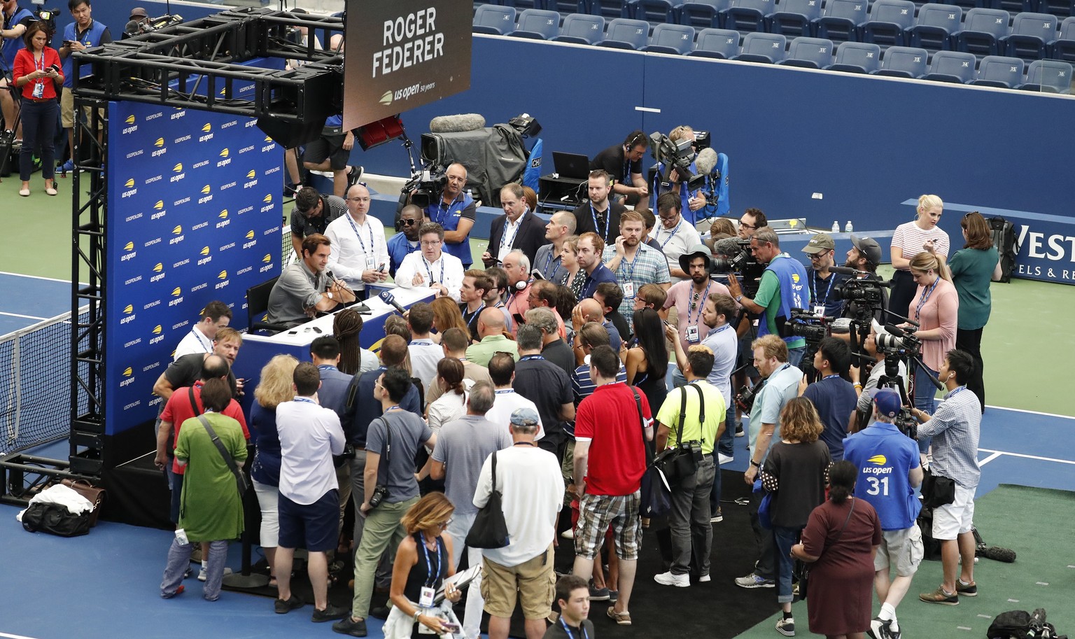 epa06969380 Swiss tennis player Roger Federer (C) addresses the media during media day inside Armstrong stadium at the 2018 US Open Tennis Championships at the USTA National Tennis Center in Flushing  ...