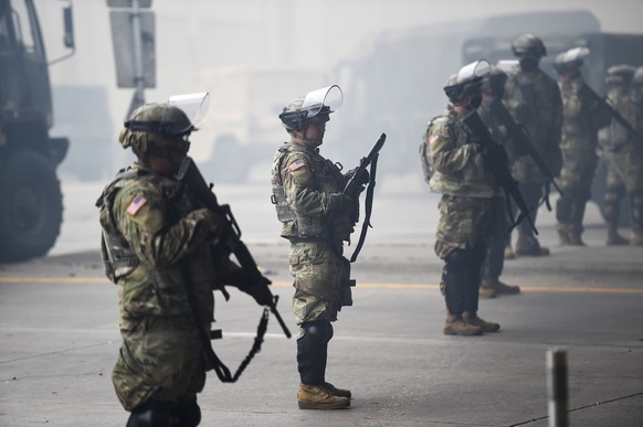 epa08452312 Minnesota National Guard deploy around the area of daily protests and looting as fires continue to burn following protests over the death of George Floyd, in Minneapolis, Minnesota, USA, 2 ...