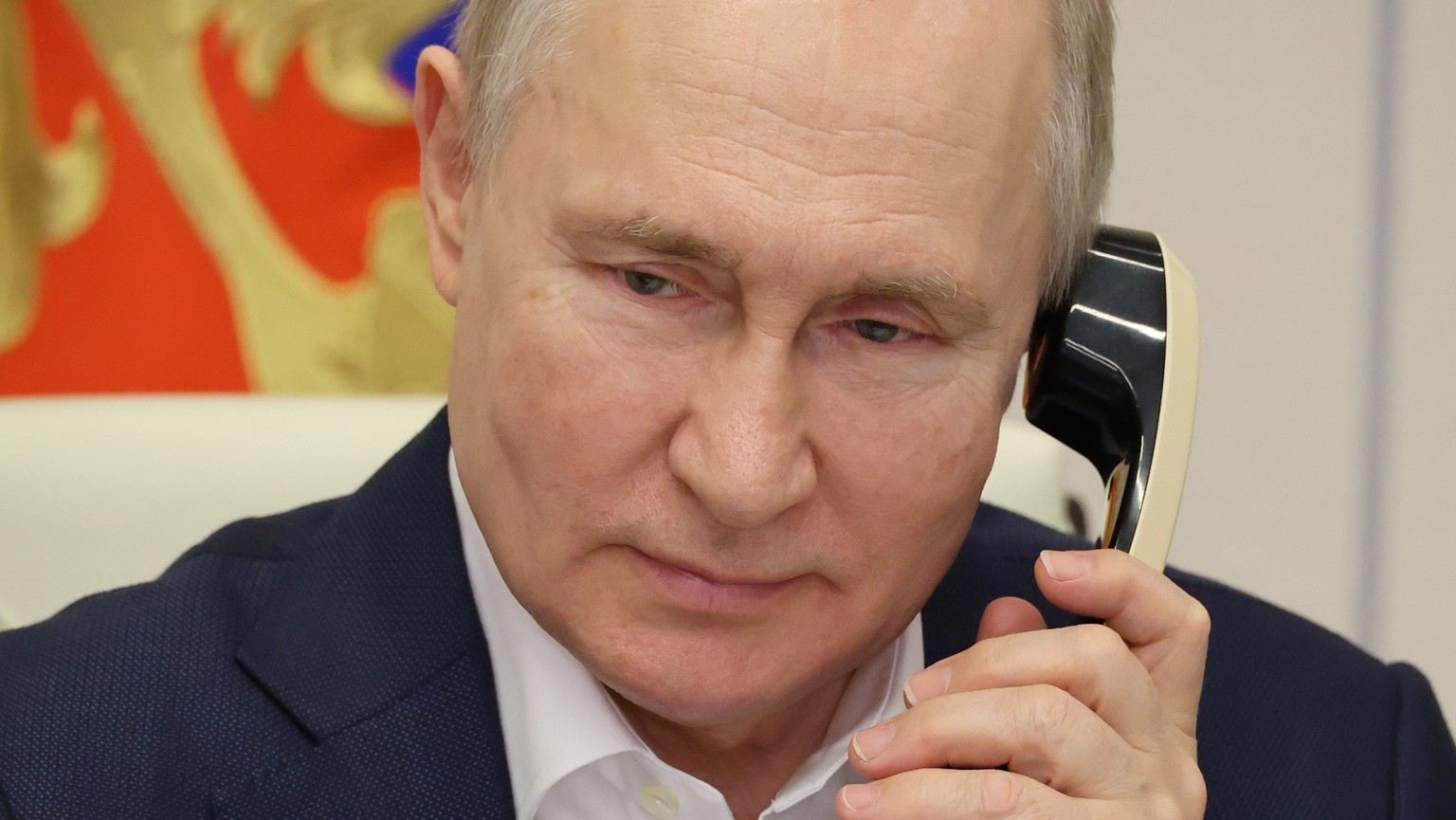 epa10387435 Russian President Vladimir Putin talks on the phone with an eight year old Agatha Bylkova from the Kurgan region, a participant of the Fir Tree of Wishes charity campaign, in Moscow, Russi ...