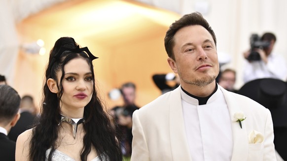 FILE - Grimes, left, and Elon Musk attend The Metropolitan Museum of Art&#039;s Costume Institute benefit gala in New York on May 7, 2018. The Tesla and SpaceX founder tells the New York Post that he  ...