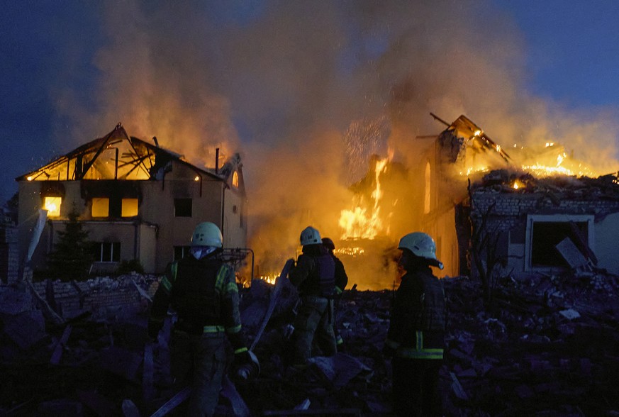 epa11330778 Ukrainian rescuers work to extinguish a fire at the site of an overnight missile strike on private buildings in Kharkiv, northeastern Ukraine, 10 May 2024, amid the Russian invasion. Khark ...