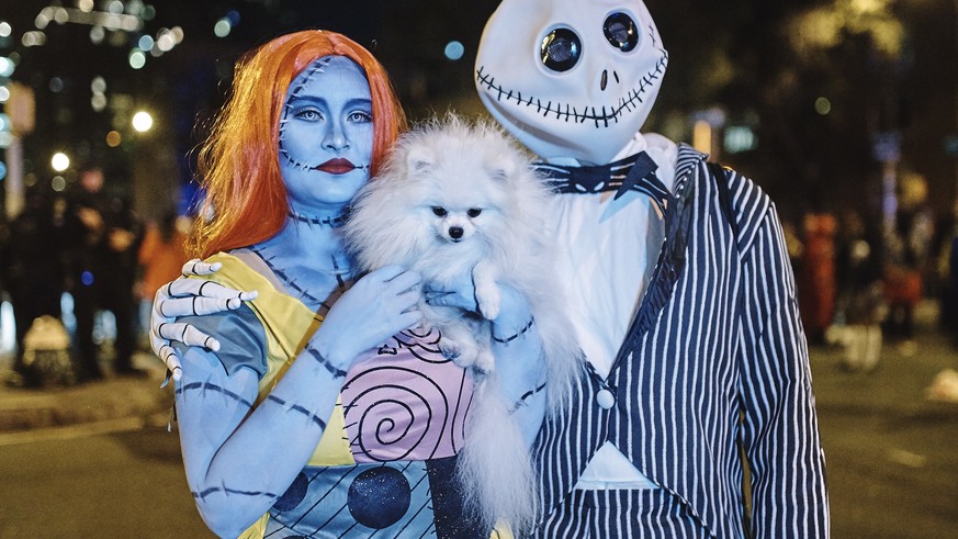 Revelers pause for a picture as they march during the Greenwich Village Halloween Parade, Tuesday, Oct. 31, 2017, in New York. (AP Photo/Andres Kudacki)