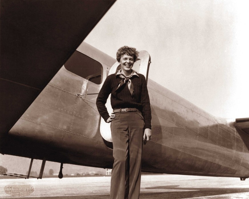 In this May 20, 1937 photo, provided by The Paragon Agency,shows aviator Amelia Earhart and her Electra plane, taken by Albert Bresnik at Burbank Airport in Burbank, Calif. It was a clear spring day i ...