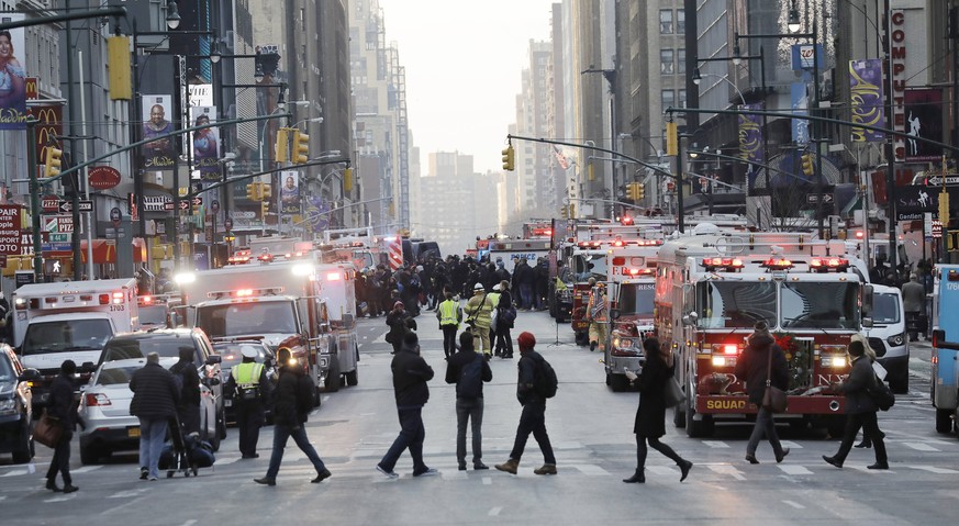 epa06383069 Police activity outside the Port Authority Bus Terminal following reports of a confirmed explosion inside an underground tunnel in the building in New York City, New York, USA, 11 December ...