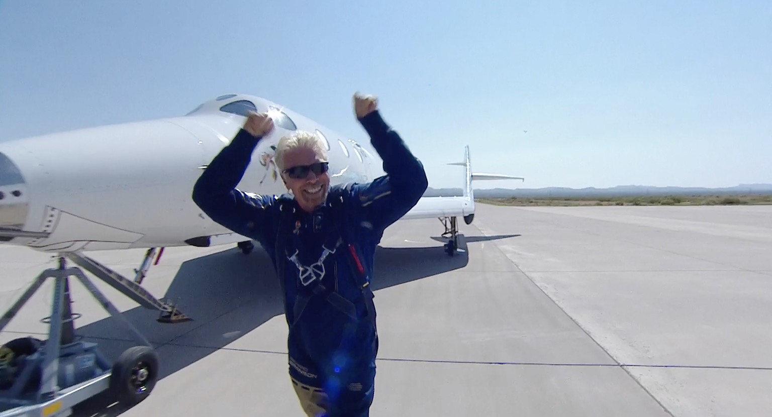 epa09339443 A framegrab from a video made available by .Virgin Galatic shows Sir Richard Branson reacting as he steps out of SpaceShip Two Unity 22 shortly after landing in a return from space to Spac ...