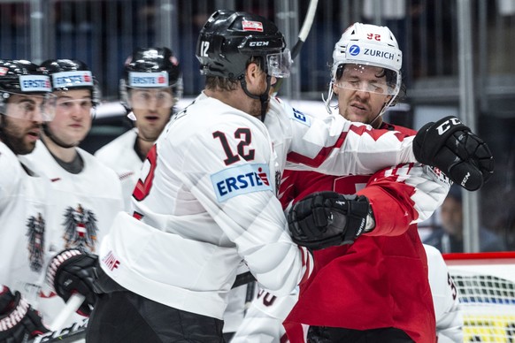 Austria`s Michael Raffl, left, fights againnst Switzerland&#039;s Gaetan Haas during the game between Switzerland and Austria, at the IIHF 2019 World Ice Hockey Championships, at the Ondrej Nepela Are ...