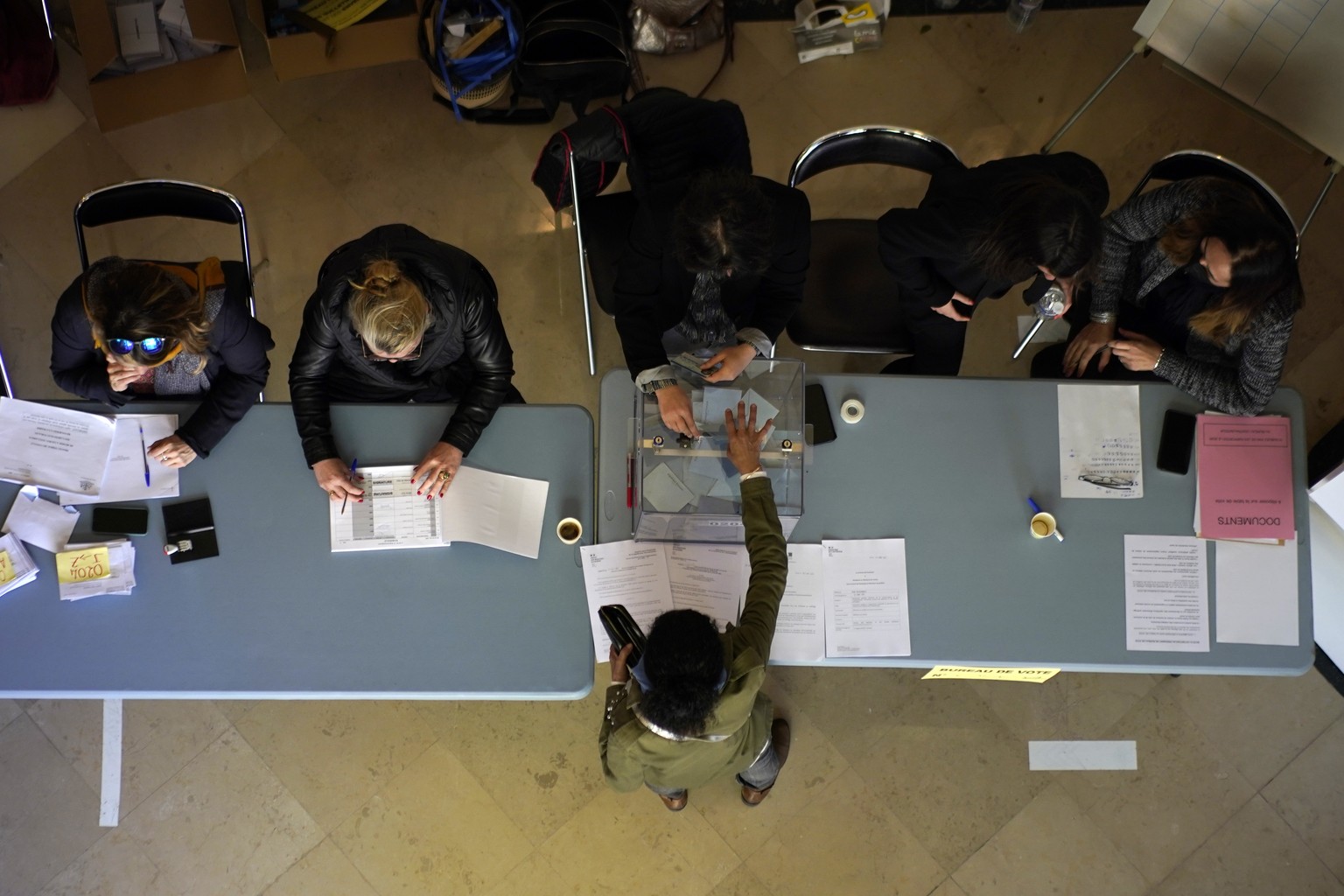 A person casts his ballot in the first round of the presidential election at a polling station Sunday, April 10, 2022 in Marseille, southern France. French citizens flocked to polling stations across  ...