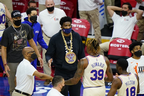 Philadelphia 76ers&#039; Ben Simmons, from left, and Joel Embiid greet Dwight Howard and Shake Milton during a timeout in the first half of an NBA basketball game against the Orlando Magic, Sunday, Ma ...