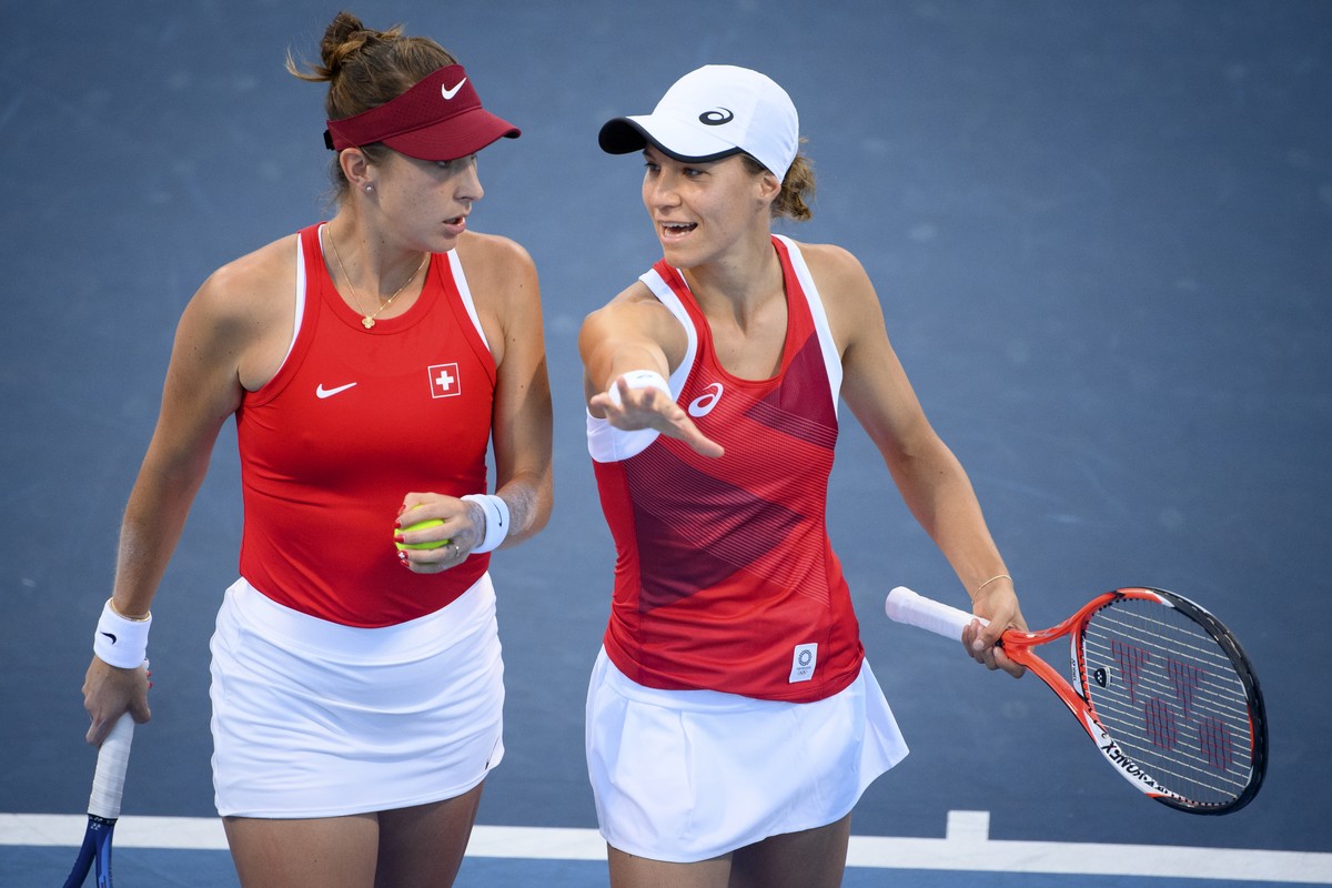 Belinda Bencic, left, and Viktorija Golubic, right, of Switzerland smile together during the game against Carla Suarez Navarro and Garbine Muguruza of Spain during the women's doubles tennis seco ...
