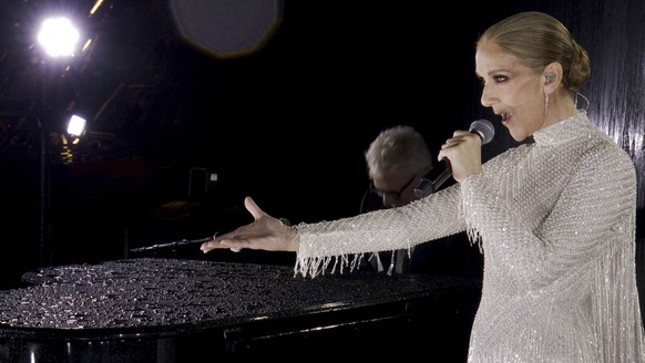 This photo released by the Olympic Broadcasting Services shows Canadian Singer Celine Dion performing at the Eiffel Tower during the opening ceremony for the 2024 Summer Olympics in Paris, France, Fri ...