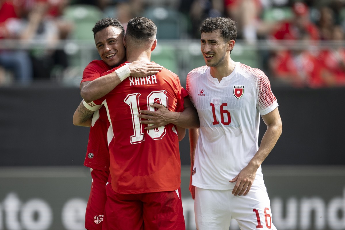 Switzerland's Dan Ndoye, left, and Granit Xhaka celebrate after scoring a penalty to 3-0, with Jordan's Mohammad Abualnadi to their right, during the friendly soccer match between Switzerlan ...