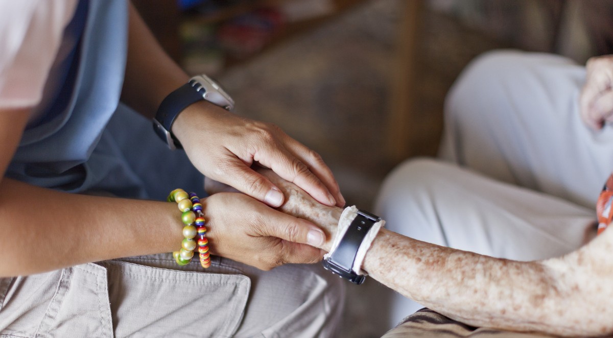 An employee of Spitex Biel, the municipal home care service, visits an elderly woman at her home in Biel, Switzerland, pictured on July 10, 2012. (KEYSTONE/Gaetan Bally)