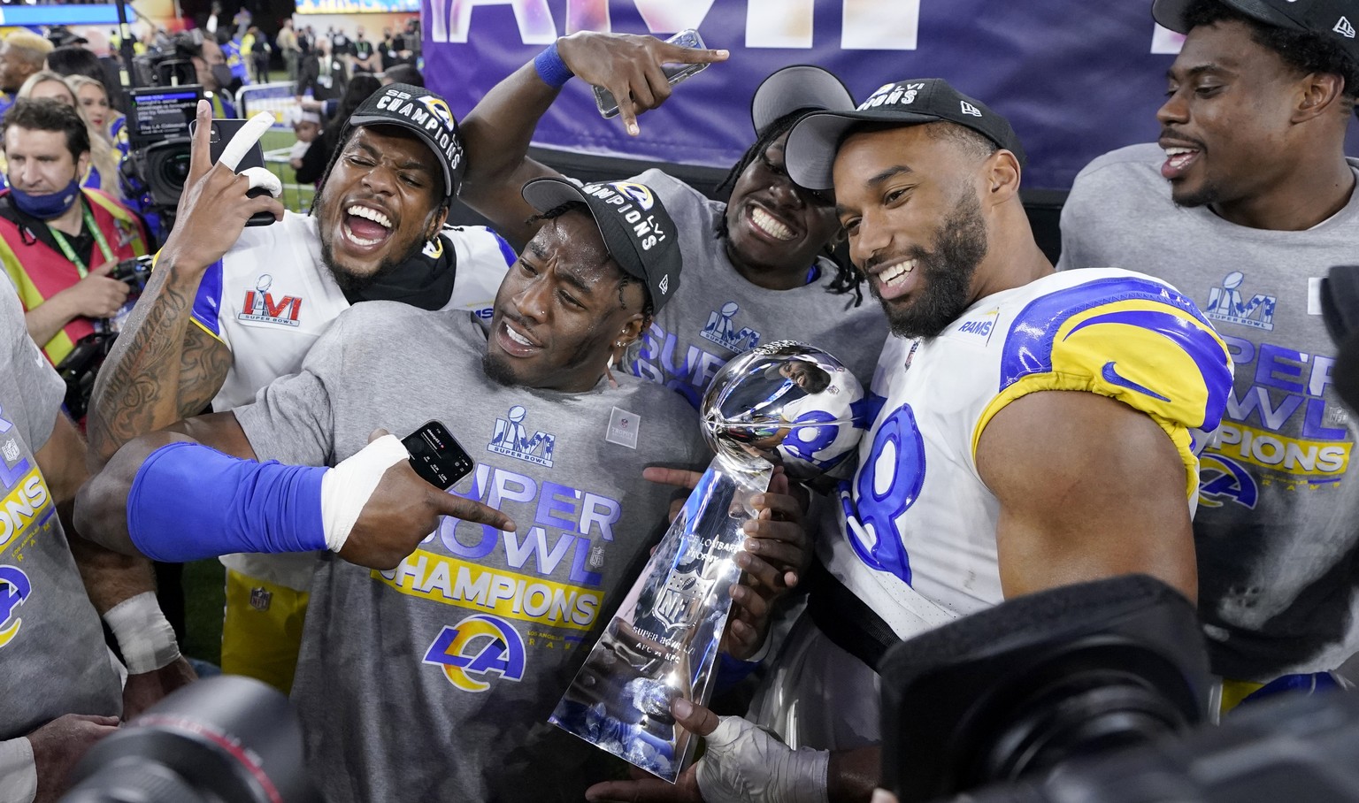 Los Angeles Rams players celebrate with the Lombardi Trophy after defeating the Cincinnati Bengals in the NFL Super Bowl 56 football game Sunday, Feb. 13, 2022, in Inglewood, Calif. (AP Photo/Mark J.  ...