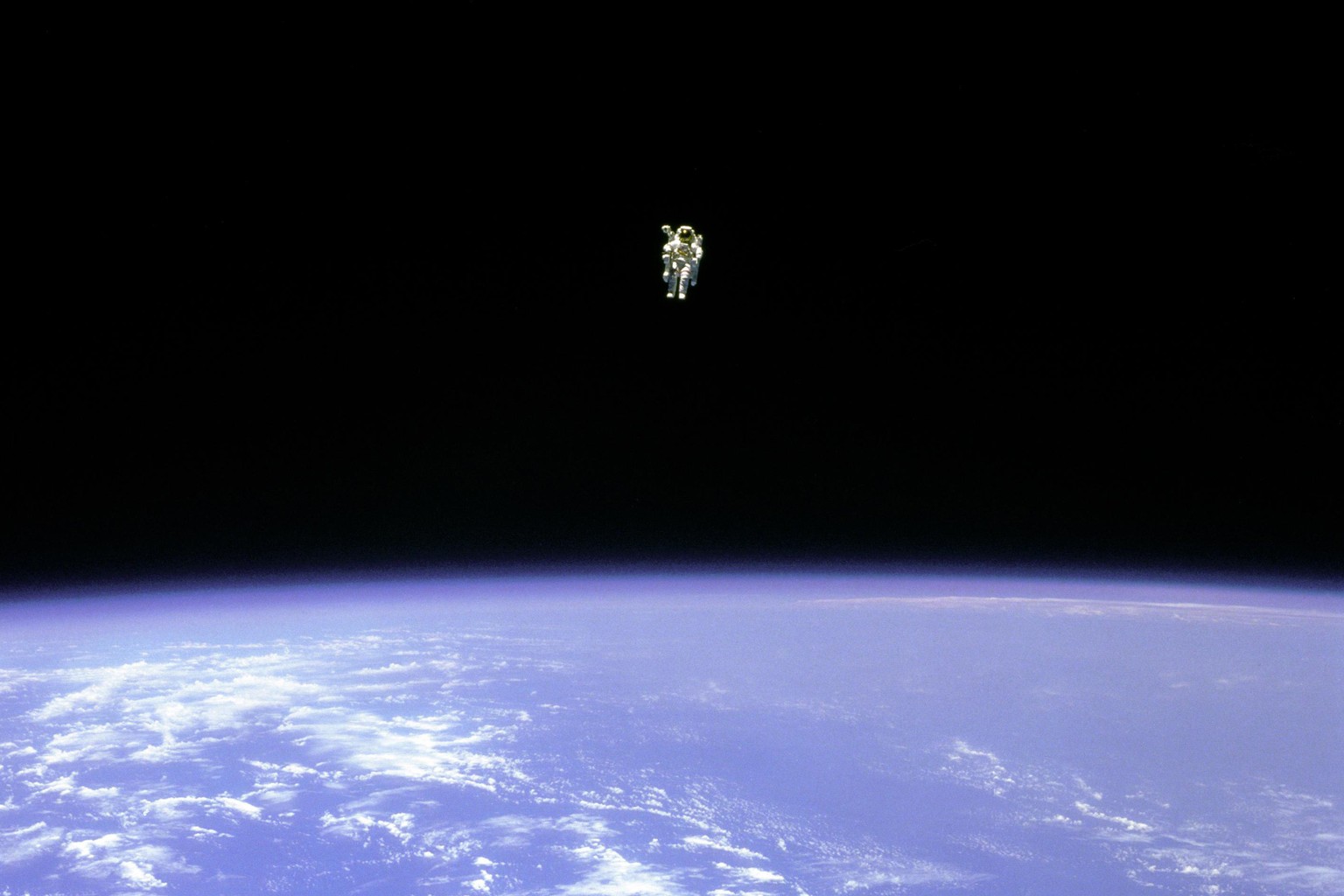 FILE - In this Feb. 12, 1984 photo made available by NASA, astronaut Bruce McCandless uses a nitrogen jet-propelled backpack, a Manned Manuevering Unit, outside the space shuttle Challenger. Astronaut ...