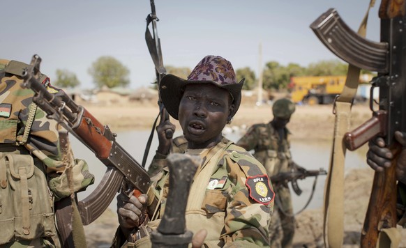 FILE - In this Sunday, Jan 12, 2014 file photo, a South Sudanese government soldier chants in celebration after government forces two days earlier retook from rebel forces the provincial capital of Be ...