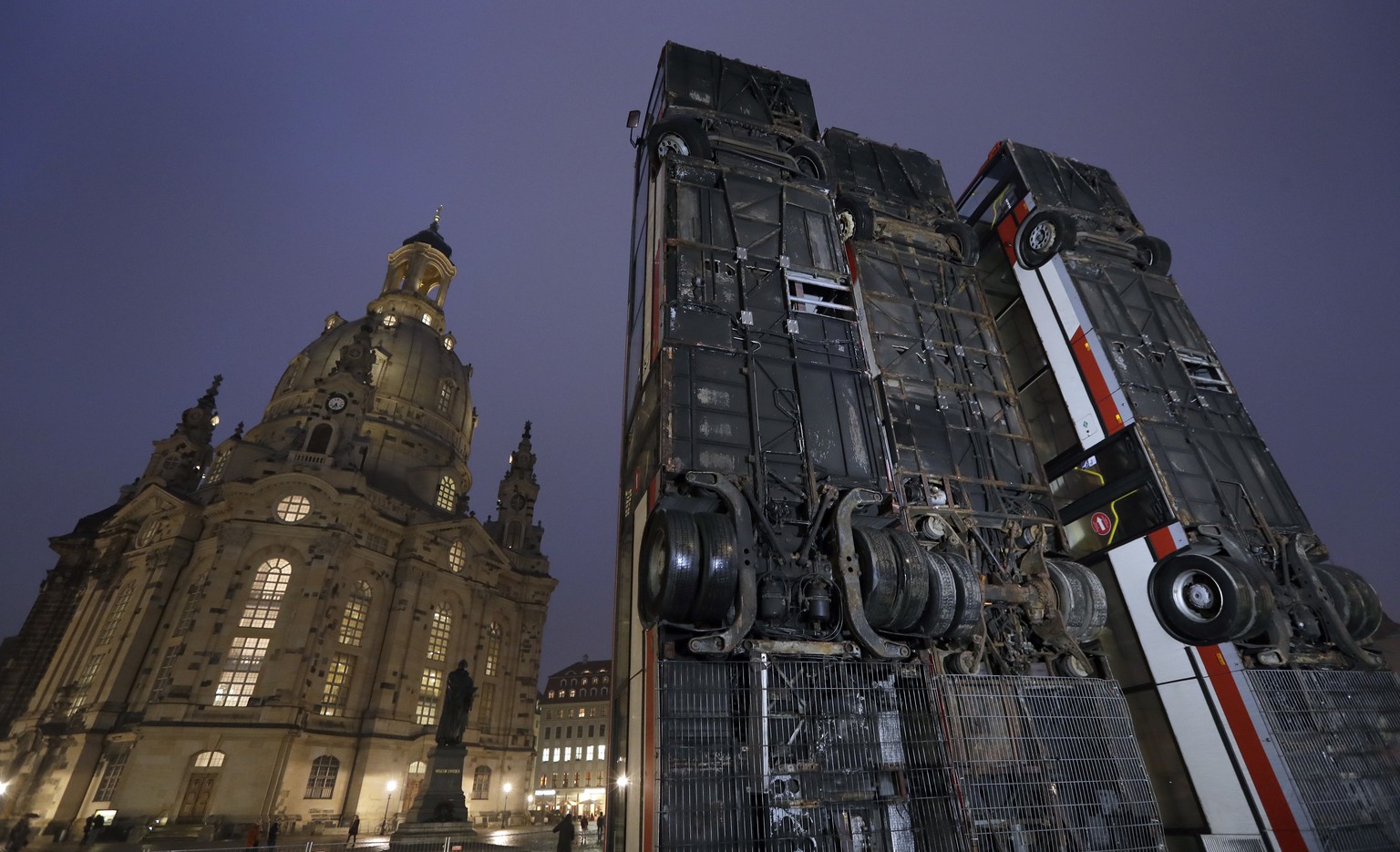 Three busses are positioned close to the &#039;Frauenkirche&#039; church in the center of the east German city of Dresden, Germany, Monday, Feb. 6, 2017. Syrian artist Manaf Halbouni placed the three  ...