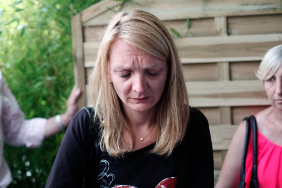 Rachel Lambert, wife of Vincent Lambert, cries as she delivers a speech to the media, at the Sebastopol hospital, in Reims, eastern France, where Vincent, who is currently on artificial life support,  ...