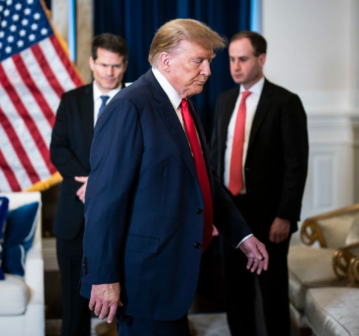 Washington, DC - January 9 : Former President Donald Trump flanked by his attorneys departs after speaking to reporters and members of the media at the Waldorf Astoria hotel following a hearing of the ...