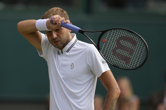 Britain&#039;s Daniel Evans prepares to serve to Sebastian Korda of the US during the men&#039;s singles third round match on day five of the Wimbledon Tennis Championships in London, Friday July 2, 2 ...