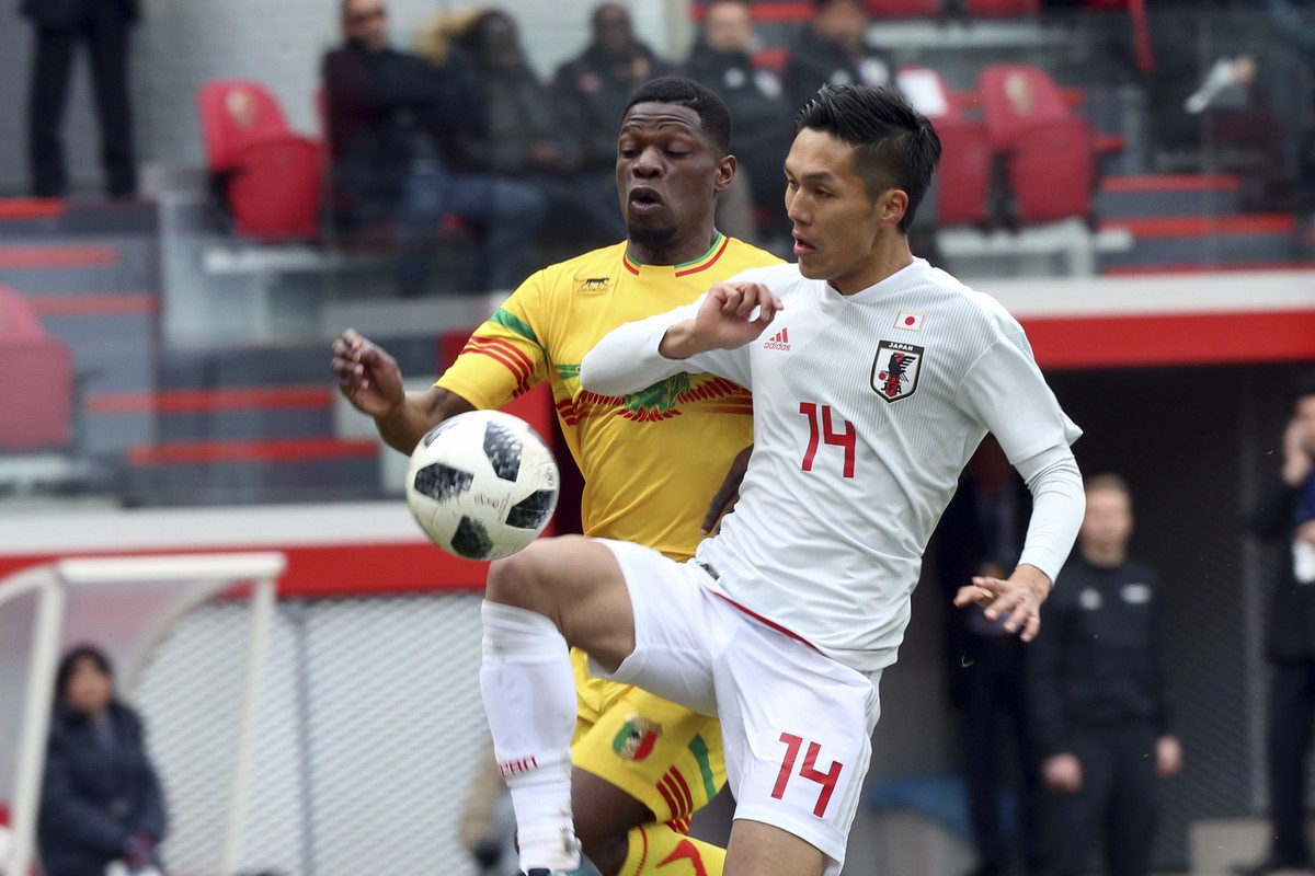 Japan's Yuya Kubo, foreground, fights for the ball with Mali's Balaye Dibassy during an international friendly soccer match between Japan and Mali at Maurice Dufrasne Stadium in Liege, Belgi ...