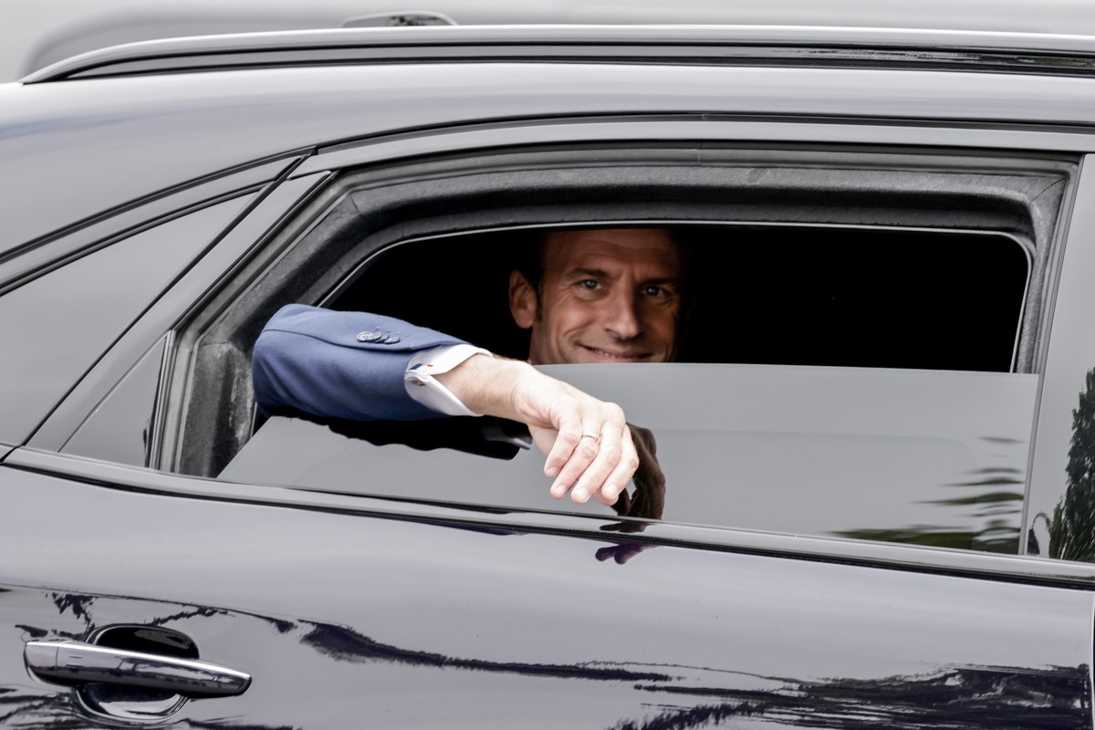 epa09933331 France's President Emmanuel Macron waves from his car as he leaves during the ceremonies marking the Allied victory against Nazi Germany and the end of World War II in Europe (VE Day) ...