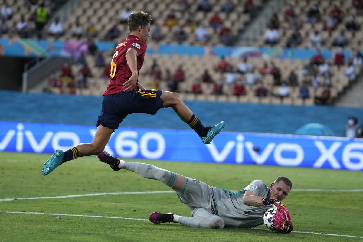 Sweden's goalkeeper Robin Olsen saves on an attempt to score by Spain's Marcos Llorente during the Euro 2020 soccer championship group E match between Spain and Sweden at La Cartuja stadium  ...