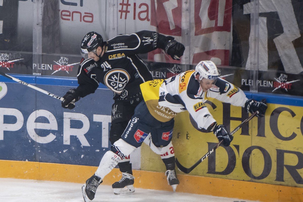 From left, LuganoÄôs player Jani Lajunen and Ambri's player Misha Moor, during the preliminary round game of National League A (NLA) Swiss Championship 2019/20 between HC Lugano and HC Ambri Pio ...