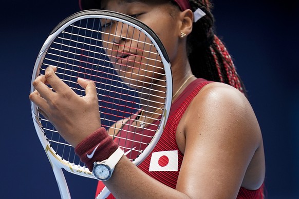 ***HOLD FOR AARON MORRISON STORY***FILE - In this July 26, 2021 file photo, Naomi Osaka, of Japan, adjusts her racket during a second round tennis match against Viktorija Golubic, of Switzerland, at t ...