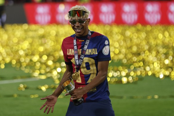 Barcelona&#039;s Lamine Yamal celebrates after winning the Spanish Copa del Rey final soccer match between Barcelona and Real Madrid at Estadio de La Cartuja stadium in Seville, Spain, Sunday, April 2 ...