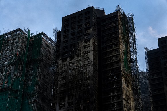 Burned buildings stand in the aftermath of a fire at Wang Fuk Court, a residential estate in the Tai Po district of Hong Kong&#039;s New Territories, Friday, Nov. 28, 2025. (AP Photo/Chan Long Hei)
Ho ...